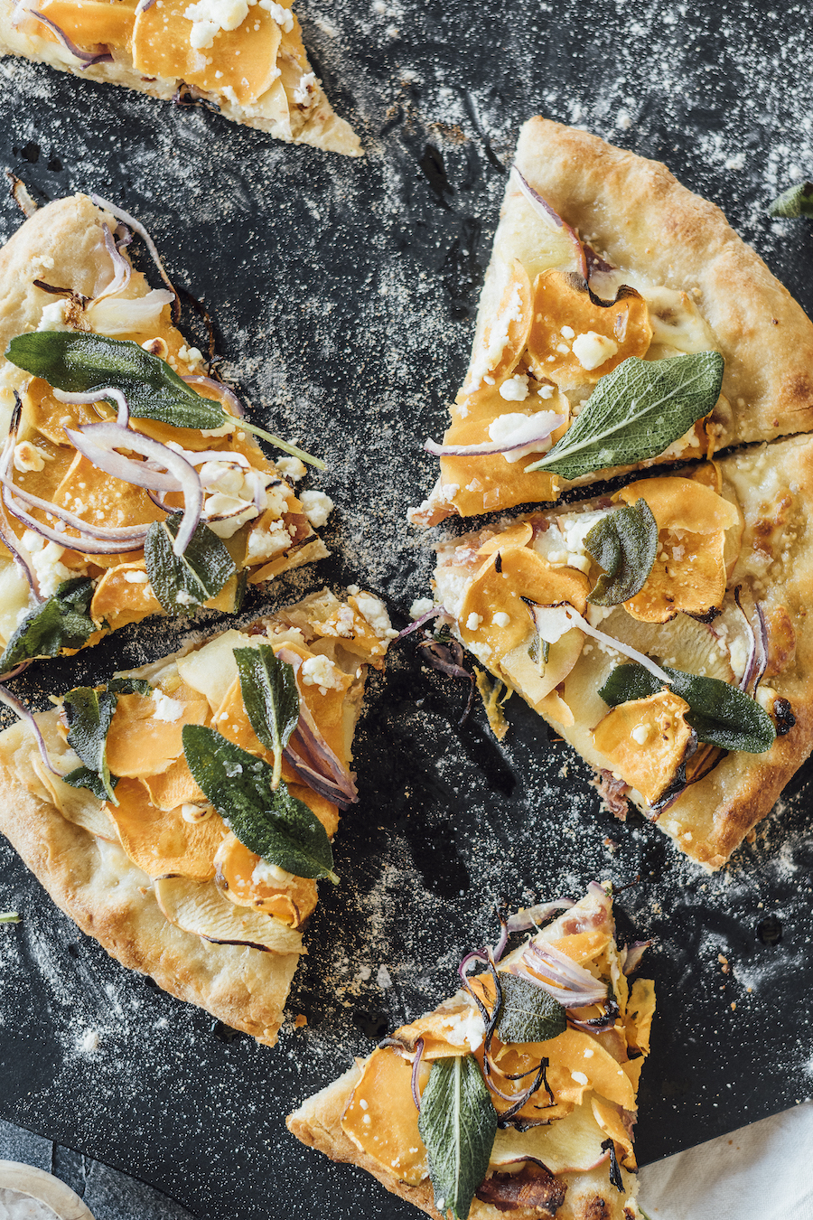 homemade fall pizza with sweet potatoes, apple, bacon and fried sage
