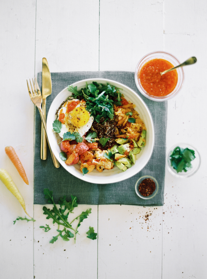Quinoa bowl with harissa-roasted veggies, avocado, and fried egg