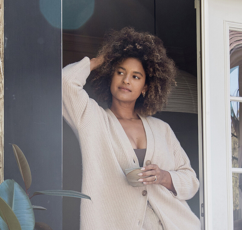Woman relaxing outside in loungewear.